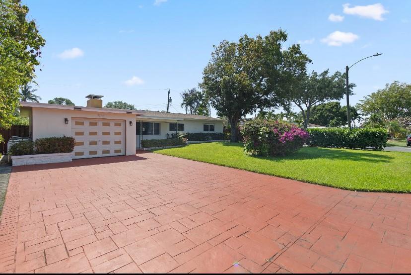 A single-story house with a red paved driveway, a garage, and a green lawn — 570 SE 2nd Avenue, Pompano Beach FL 33060, POMPANO BEACH, FL