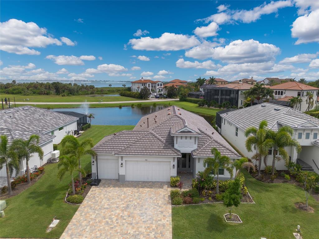 An aerial view of a suburban house with a tiled roof and a paved driveway — 5504 TITLE ROW DRIVE, BRADENTON, FL
