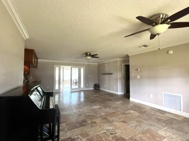 A living room features tile flooring, two ceiling fans, and a piano in the foreground — 36911 3rd Street, Canal Point FL 33438, CANAL POINT, FL