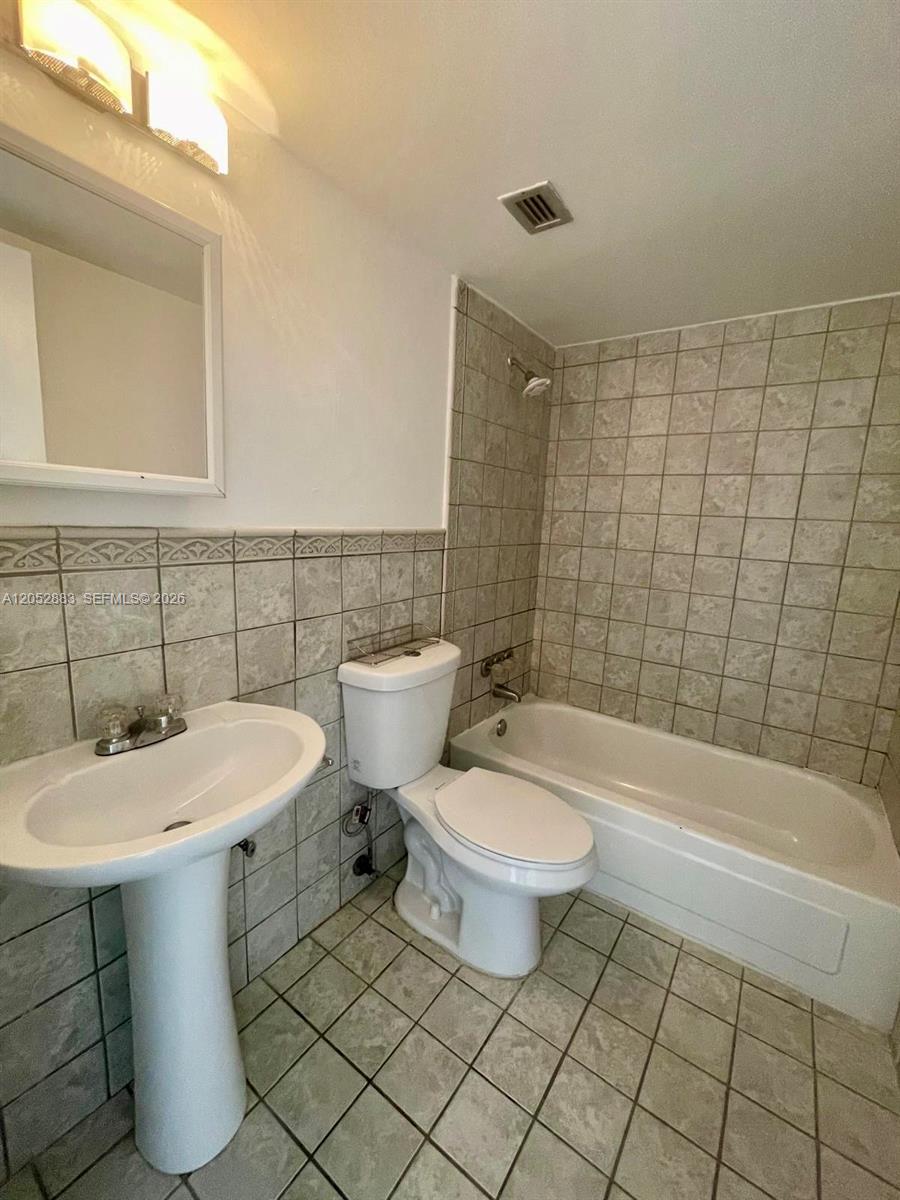 This bathroom features a pedestal sink, a toilet, and a tiled shower-tub combination — 13155 Ixora Ct # 201, North Miami FL 33181, NORTH MIAMI, FL