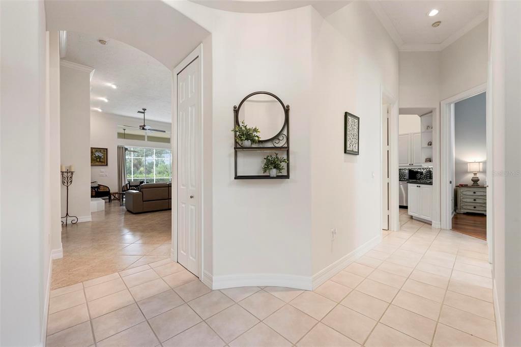 A tiled entryway leads to a living room on the left and a kitchen beyond — 29 SAINT JOHN BOULEVARD UNIT 5, ENGLEWOOD, FL