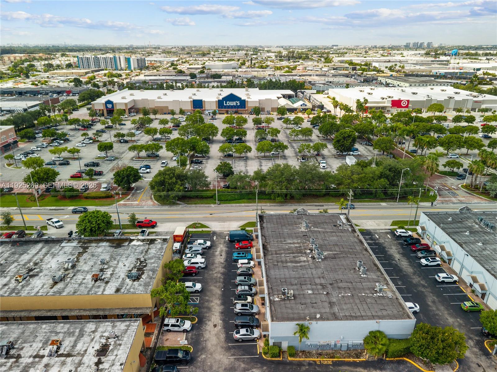 An aerial view shows a commercial parking lot with a Lowe's and Target in the background — 1671 W 37th St # 2, Hialeah FL 33012, HIALEAH, FL