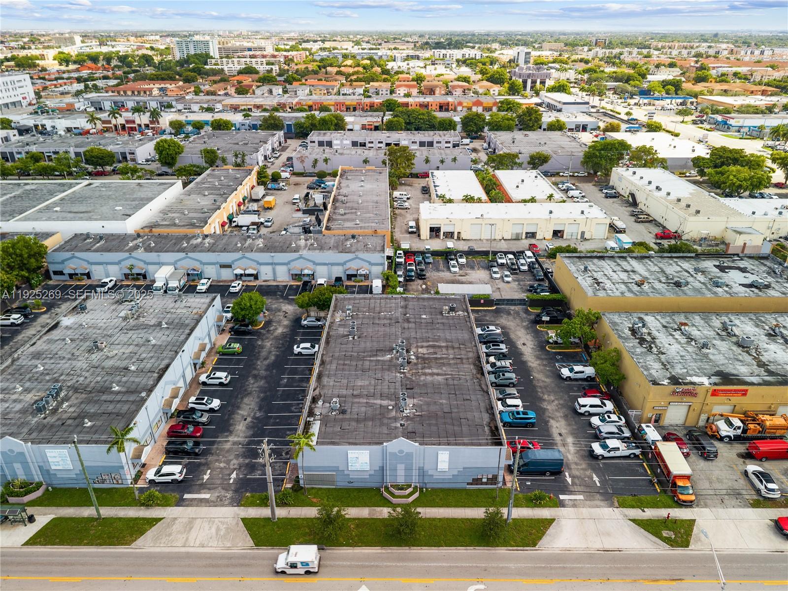 An aerial view shows several commercial warehouse buildings with parking lots in an urban area — 1671 W 37th St # 2, Hialeah FL 33012, HIALEAH, FL