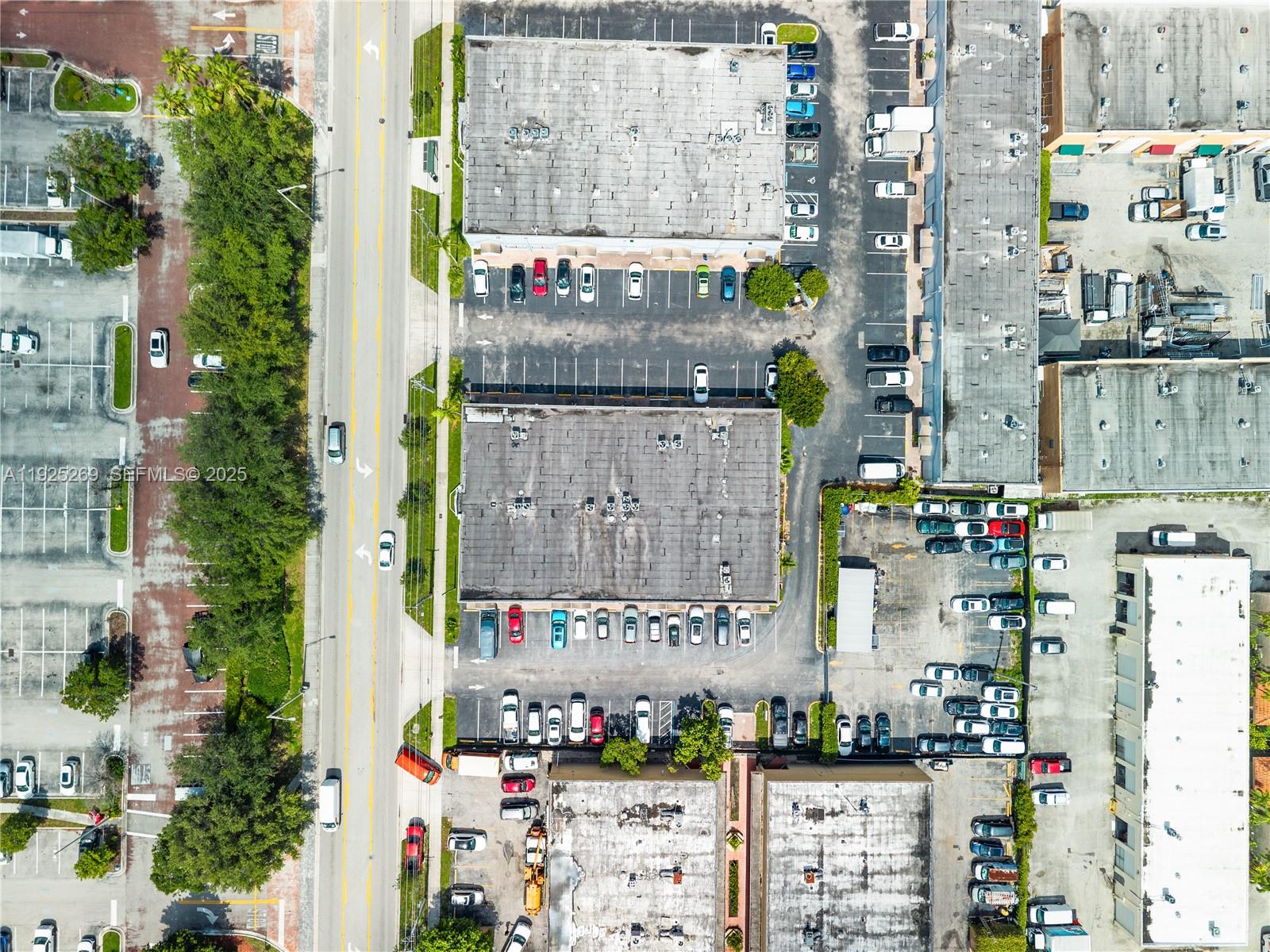 This aerial view shows commercial buildings with parking lots and a road — 1671 W 37th St # 2, Hialeah FL 33012, HIALEAH, FL
