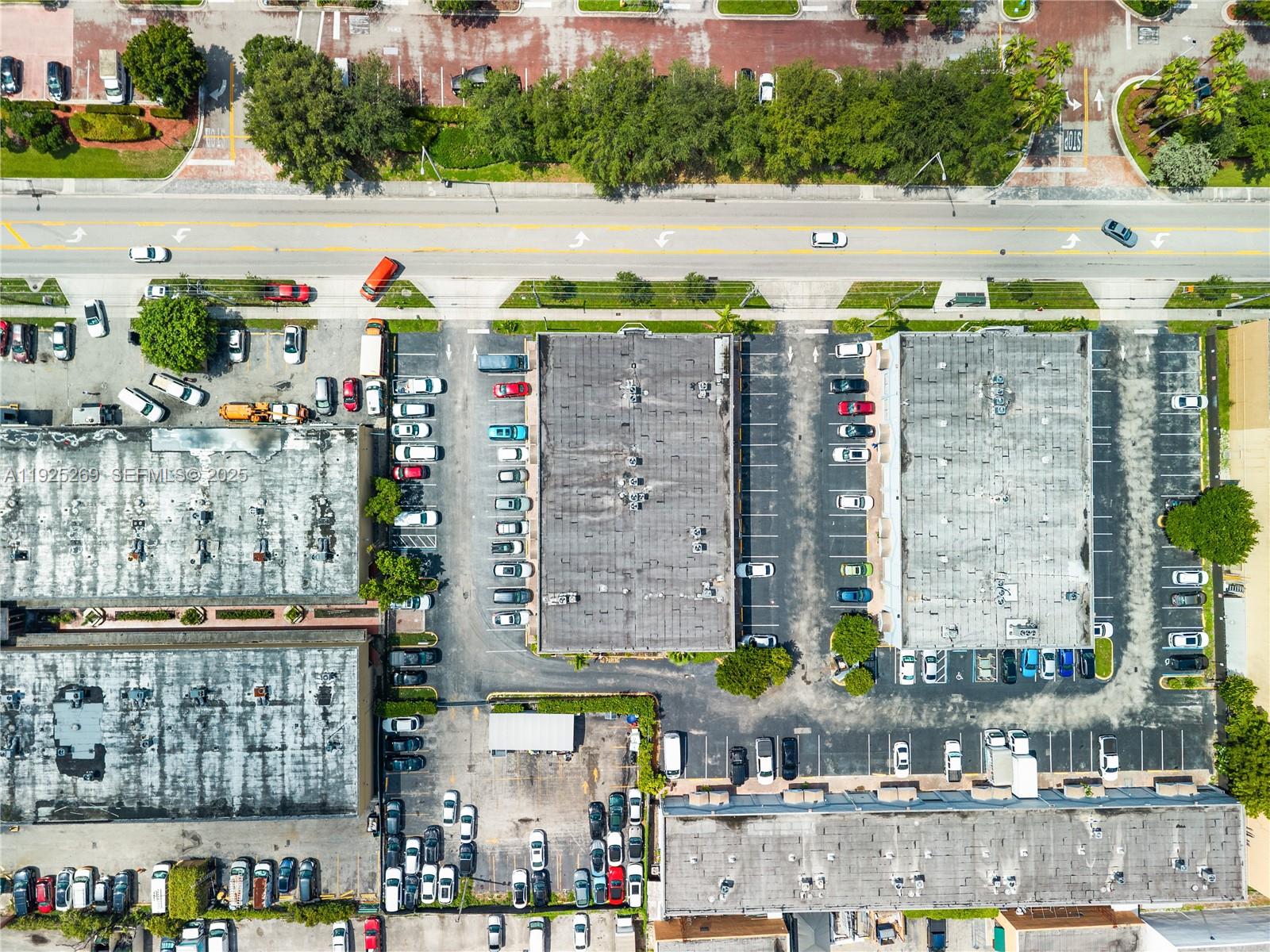 An aerial view shows multiple commercial buildings surrounded by parking lots and a nearby road — 1671 W 37th St # 2, Hialeah FL 33012, HIALEAH, FL