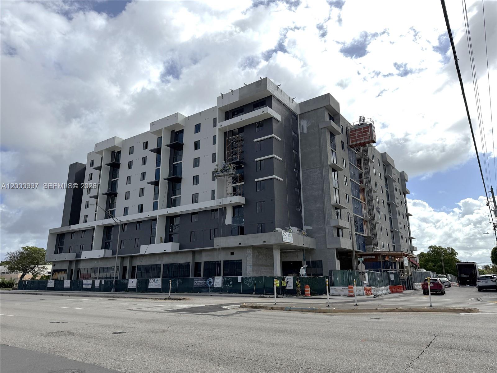 A multi-story apartment building under construction stands near a street intersection under a cloudy sky — 315 NW 27th Ave # 504, Miami FL 33125, MIAMI, FL