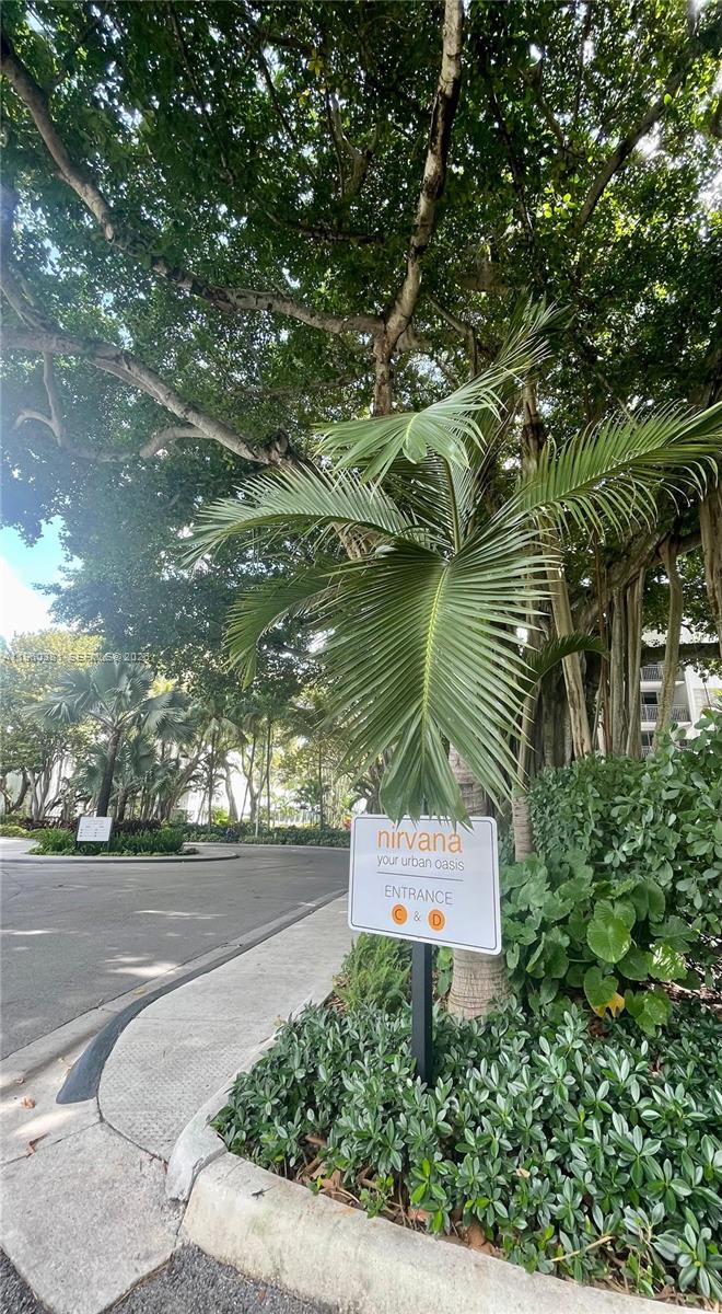 A sign for Nirvana entrance C and D stands near a palm tree and driveway — 700 NE 63rd St # D203, Miami FL 33138, MIAMI, FL