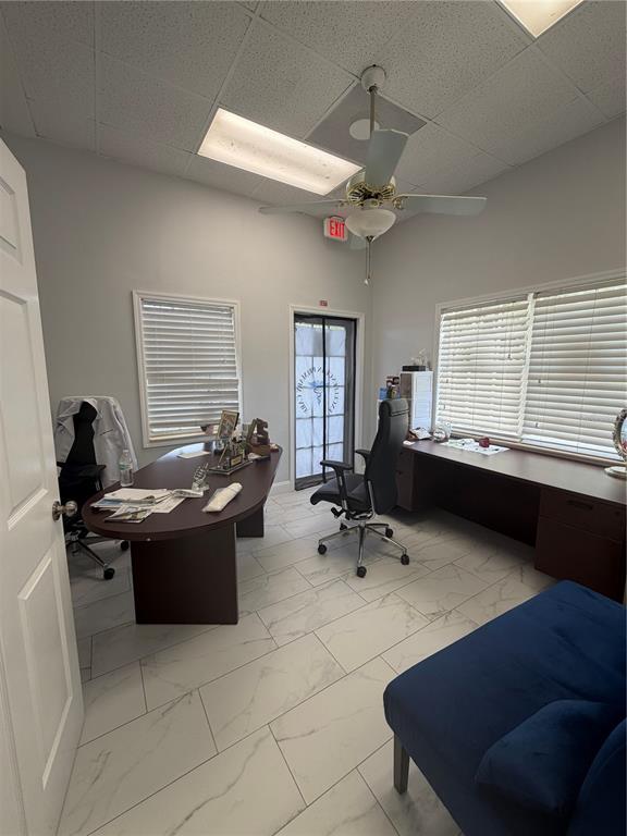 An office features a desk, a rolling chair, a blue sofa, and tile flooring — 2716 REW CIRCLE, OCOEE, FL