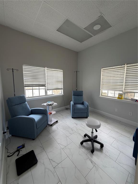 A medical infusion room features two blue recliners, IV poles, and white marble-look tile flooring — 2716 REW CIRCLE, OCOEE, FL