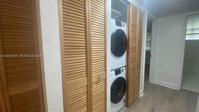A stacked washer and dryer unit is housed in a closet with louvered wooden doors — 7915 SW 86th St # 726, Miami FL 33143, MIAMI, FL