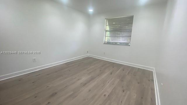 An empty bedroom features white walls, light wood-look flooring, and a single window — 7915 SW 86th St # 726, Miami FL 33143, MIAMI, FL