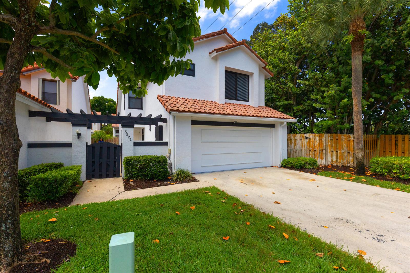 A two-story white house with a tile roof, a garage, and a gated entryway — 5521 Ilford Court, Boca Raton FL 33486, BOCA RATON, FL