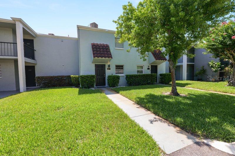 A two-story apartment building with light green stucco walls and a concrete walkway — 2862 SOMERSET PARK DRIVE UNIT 2862, TAMPA, FL