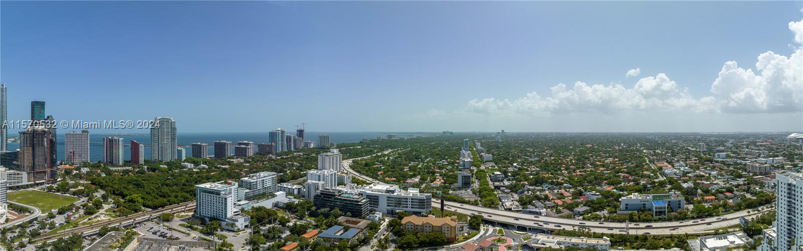 An elevated panoramic view shows a city skyline, a highway, and surrounding residential areas — 1133 SW 2nd Ave # 3816, Miami FL 33130, MIAMI, FL