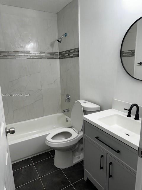 A bathroom features a white bathtub, a toilet, and a gray vanity with a round mirror — 6970 NW 177th St # M104, Hialeah FL 33015, HIALEAH, FL