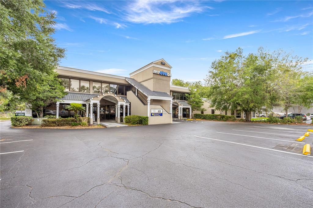 A two-story commercial building with a parking lot in the foreground — 3101 SW COLLEGE ROAD UNIT 200/204, OCALA, FL