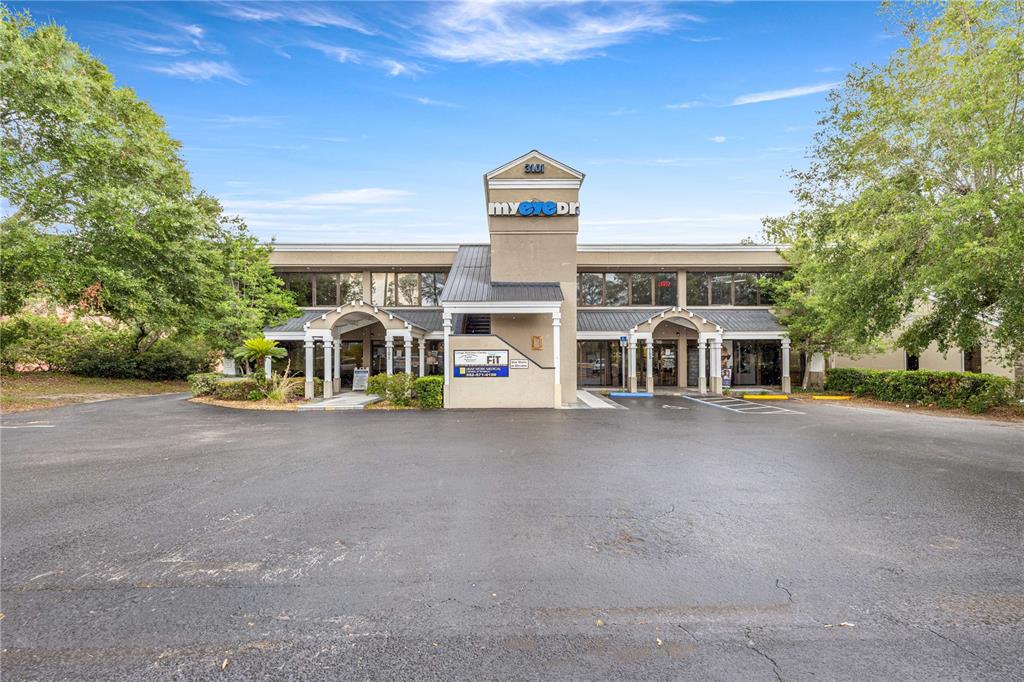 A two-story commercial building with a central tower and a large paved parking lot — 3101 SW COLLEGE ROAD UNIT 200/204, OCALA, FL