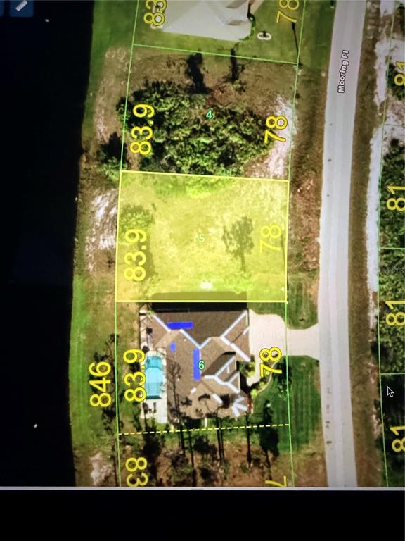 This is an aerial map showing a residential lot highlighted in yellow next to a house — 16 MOORING PLACE, PLACIDA, FL