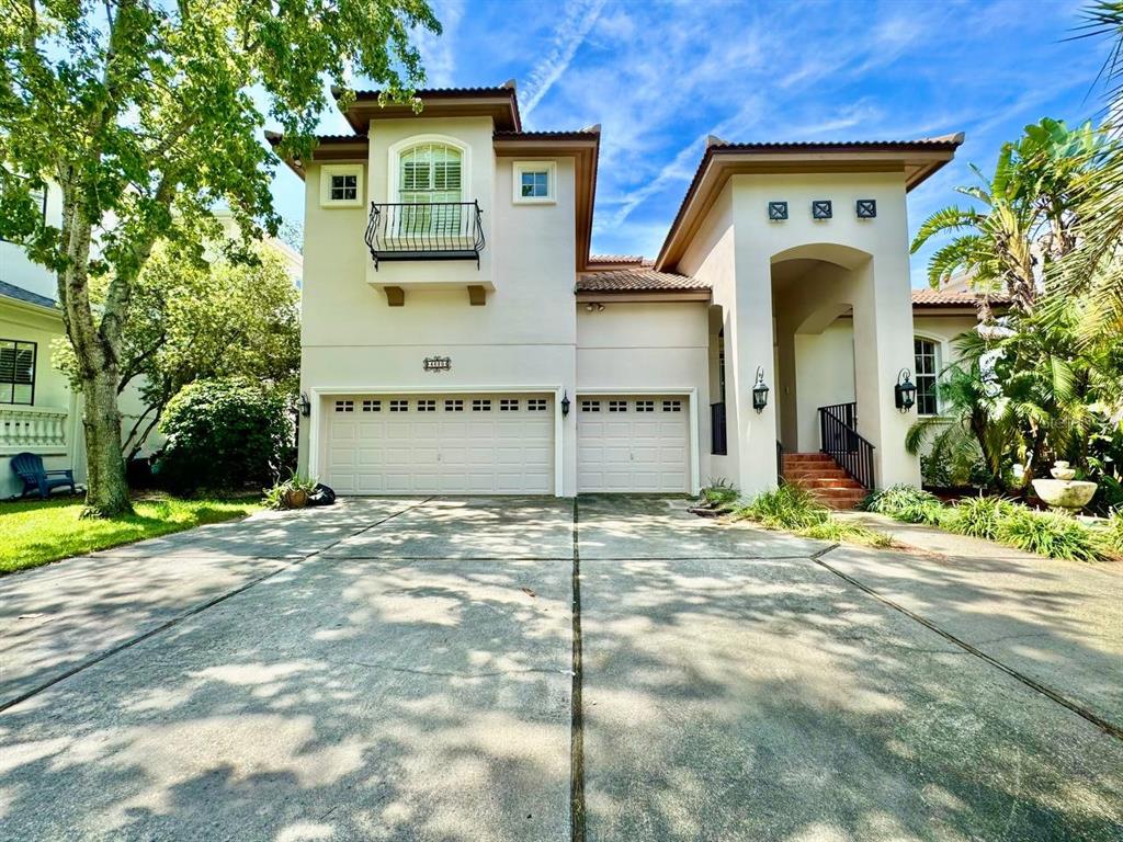 A two-story house with a three-car garage, a balcony, and a covered entryway — 4620 W BROWNING AVENUE, TAMPA, FL