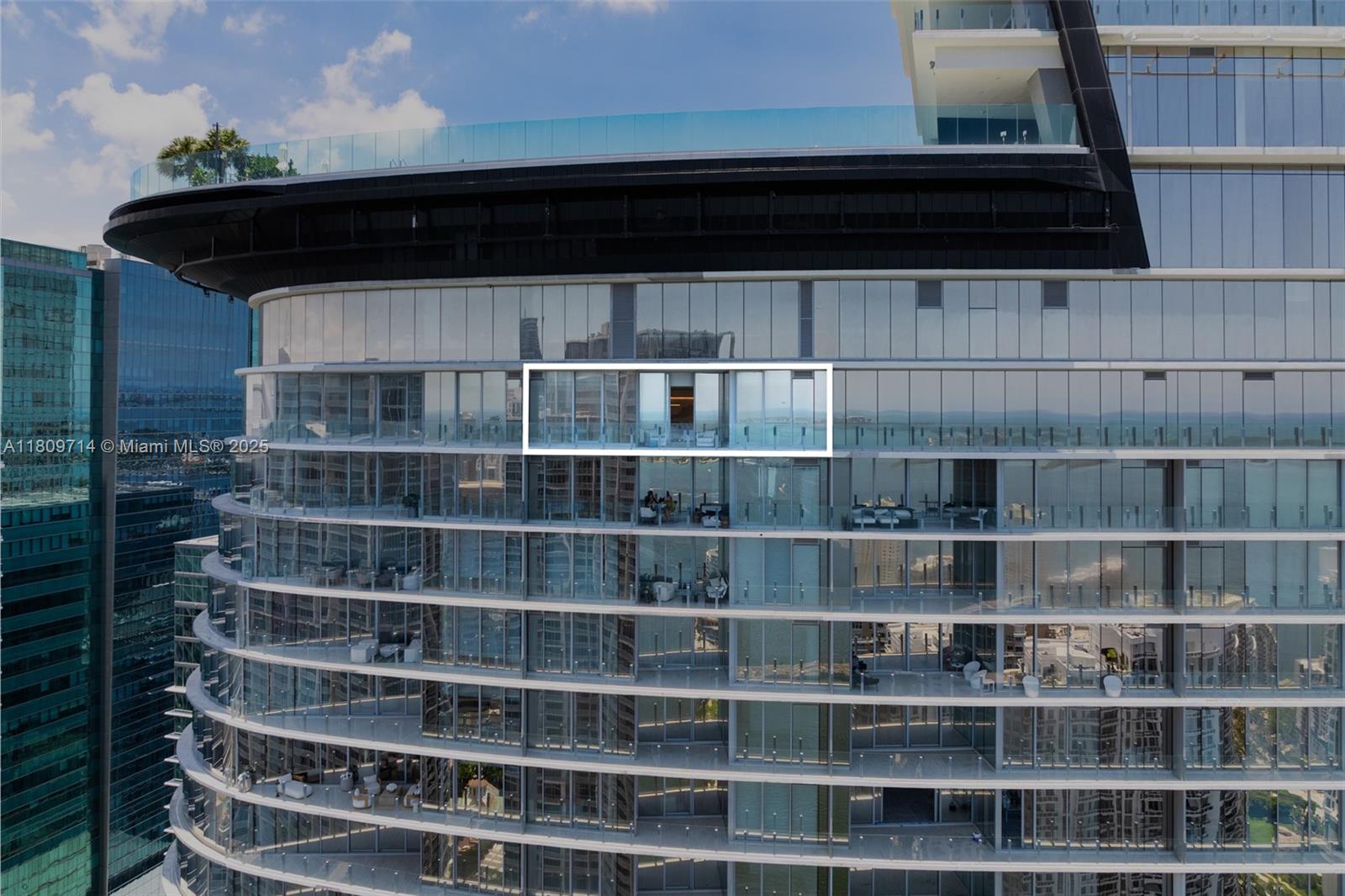 An exterior view of a high-rise building featuring glass balconies and floor-to-ceiling windows — 300 Biscayne Blvd Way # 5205W, Miami FL 33131, MIAMI, FL
