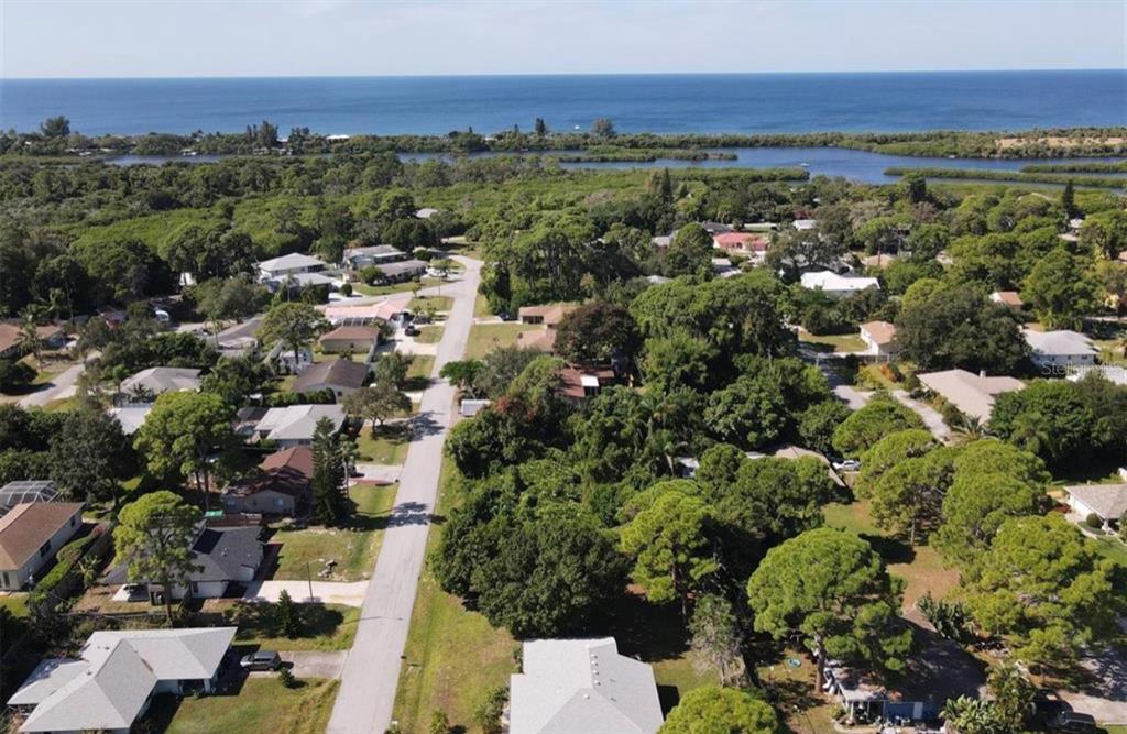 An aerial view shows a residential street leading toward a coastal waterway and the ocean — SOUTHLAND ROAD, VENICE, FL