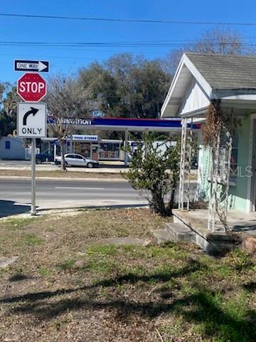 A view of a street corner with a stop sign, a gas station, and a house — 20371 E MCKINNEY AVENUE, DUNNELLON, FL