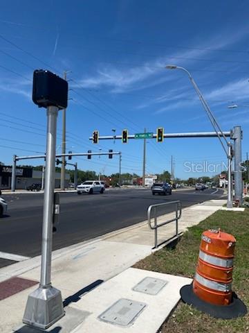 A street intersection with traffic lights, a pedestrian signal pole, and an orange traffic barrel — 20371 E MCKINNEY AVENUE, DUNNELLON, FL