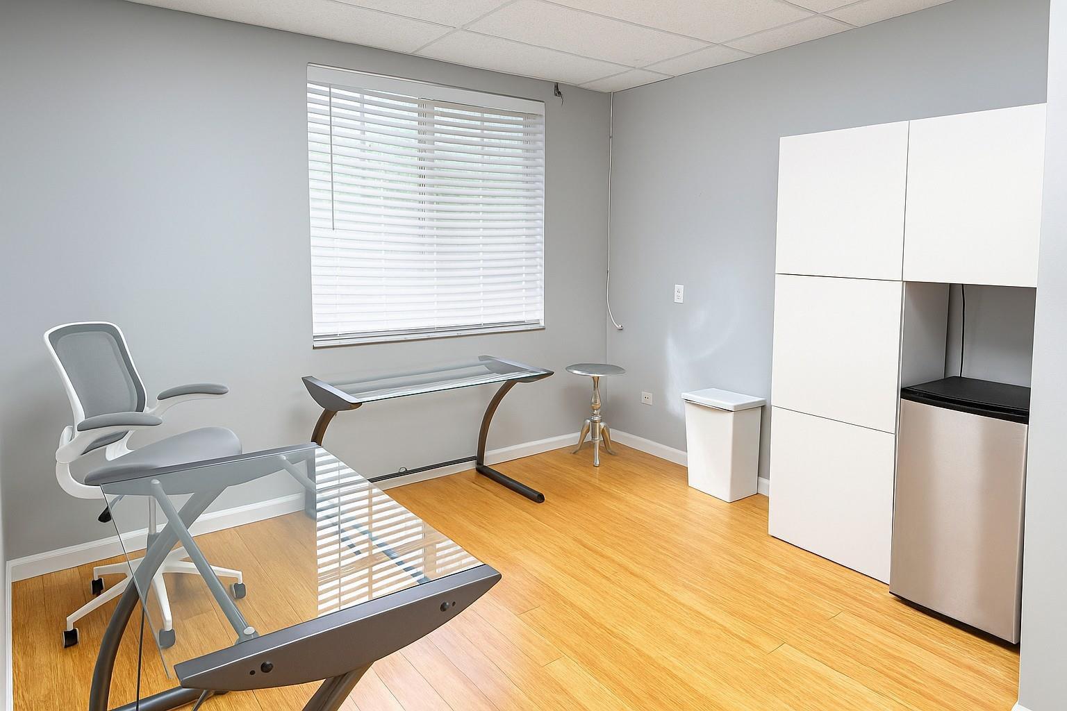 A home office features a glass desk, a mesh chair, and a white storage unit — 5595 Orange Drive # 201, Davie FL 33314, DAVIE, FL