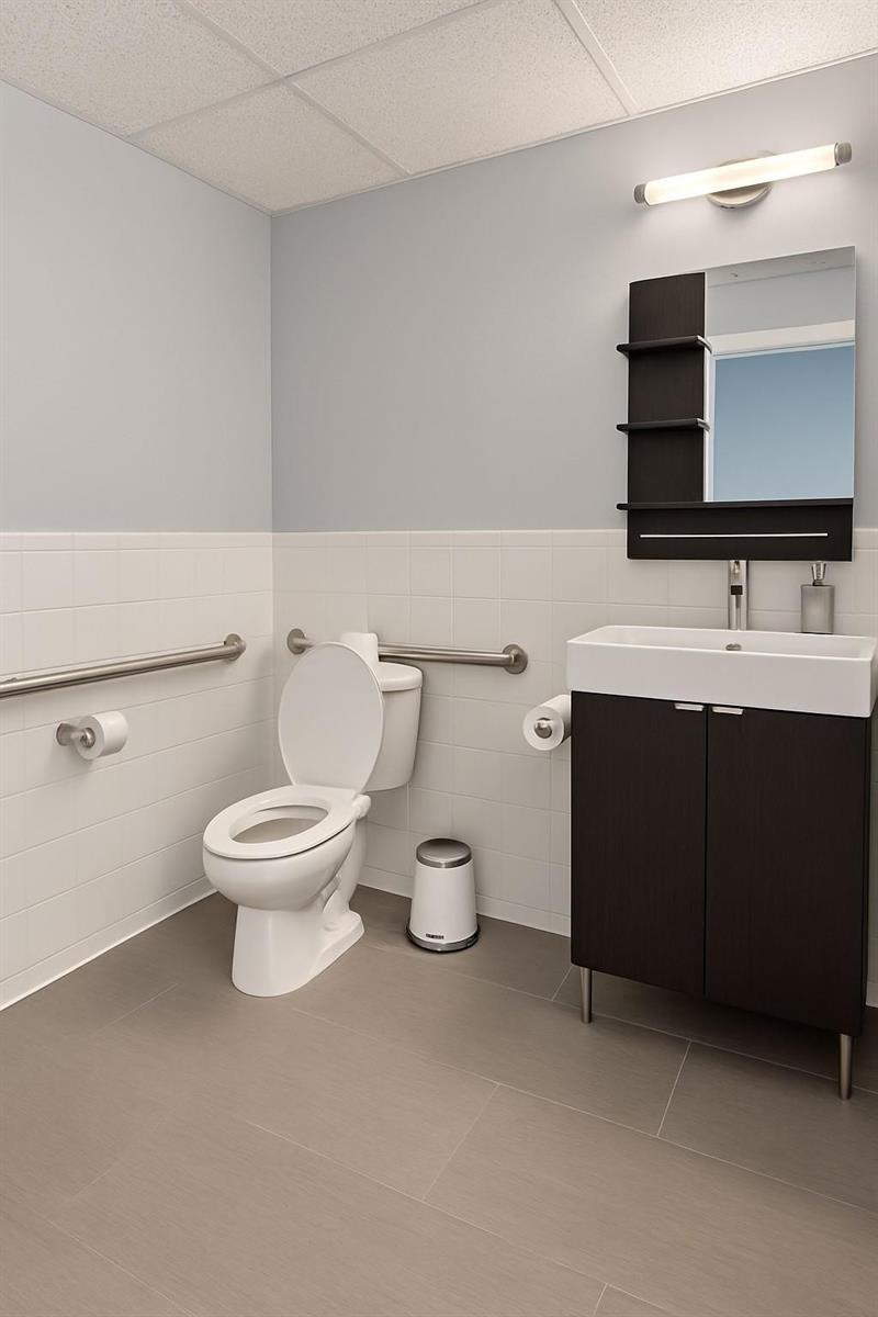 This is a rendering of an accessible bathroom with a toilet, vanity, and grab bars — 5595 Orange Drive # 201, Davie FL 33314, DAVIE, FL