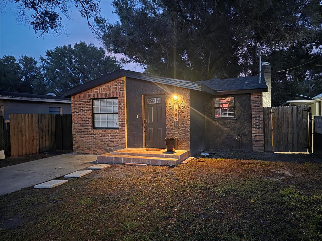 A single-story house with a brick and stucco exterior, a front porch, and a driveway — 4607 N 35TH STREET, TAMPA, FL