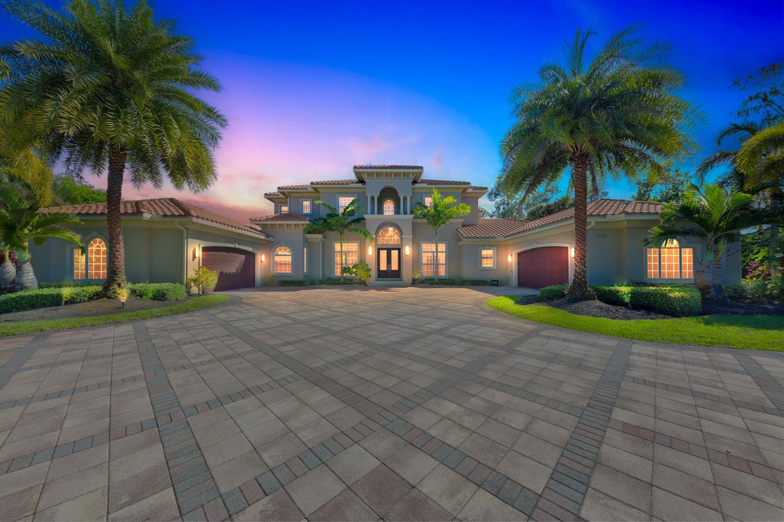 A large two-story house with a paved driveway, palm trees, and a tile roof — 13550 Greentree Trail, Wellington FL 33414, WELLINGTON, FL