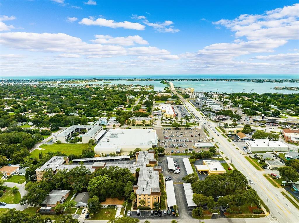 Aerial view of a residential and commercial area near a coastal bridge and water — 2525 W BAY DRIVE UNIT A16, LARGO, FL
