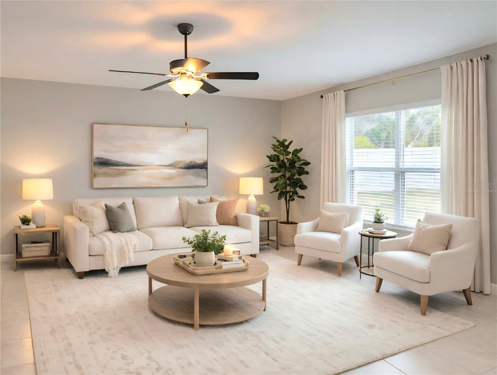 A living room features a beige sofa, two armchairs, a round coffee table, and a ceiling fan — 10316 SHADY PRESERVE DRIVE, RIVERVIEW, FL