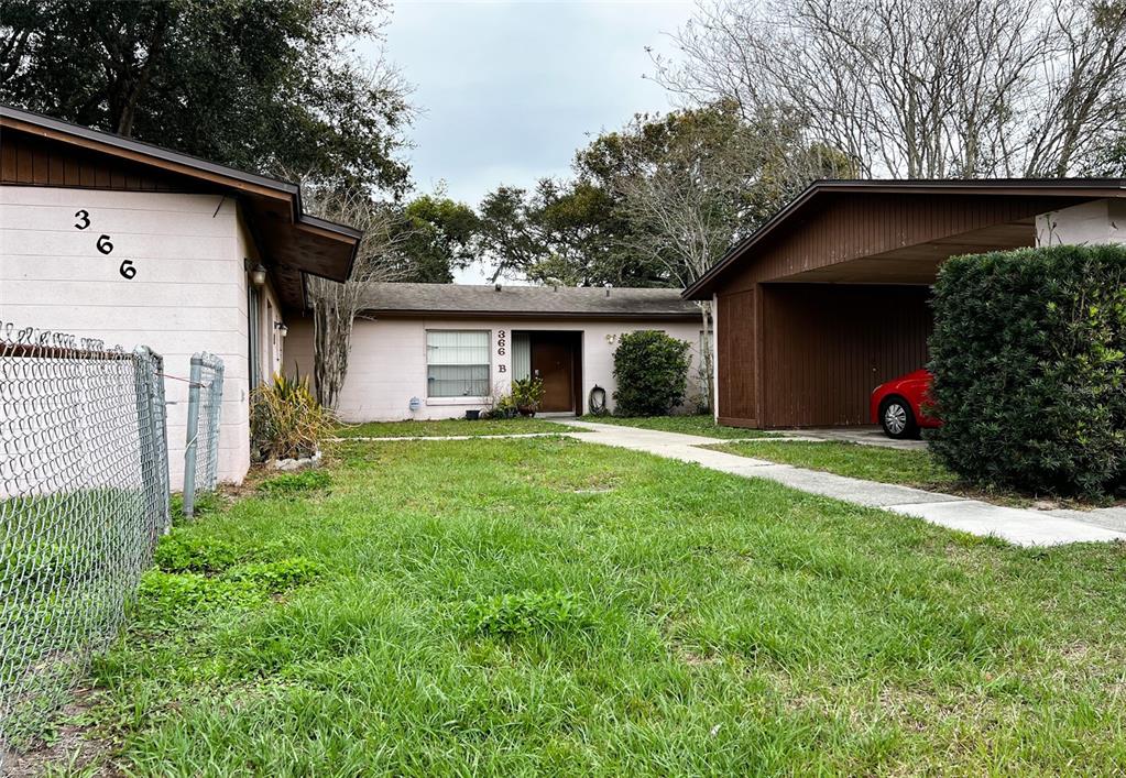 A single-story building with a carport and a grassy front yard — 366 DIAMOND STREET, DELTONA, FL