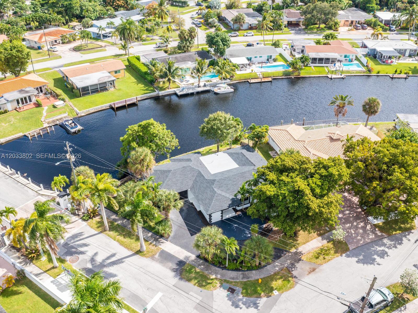 An aerial view shows a house with a dark roof situated along a canal — 2856 NW 10th Ave, Wilton Manors FL 33311, WILTON MANORS, FL