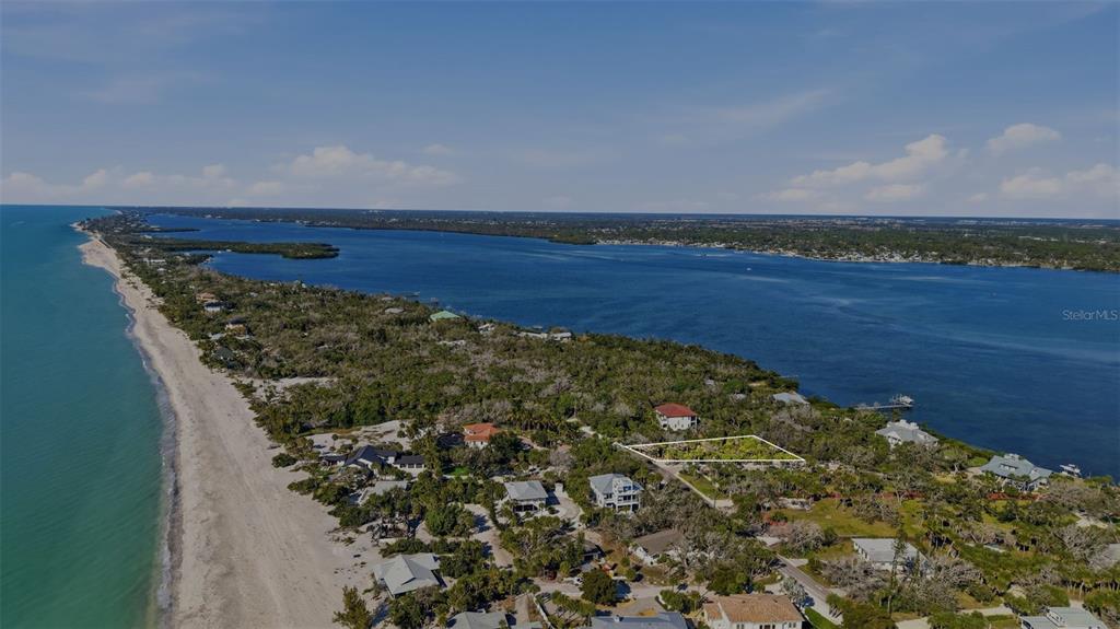 An aerial view shows a coastal landscape with a highlighted vacant lot near the beach — MANASOTA KEY ROAD, ENGLEWOOD, FL