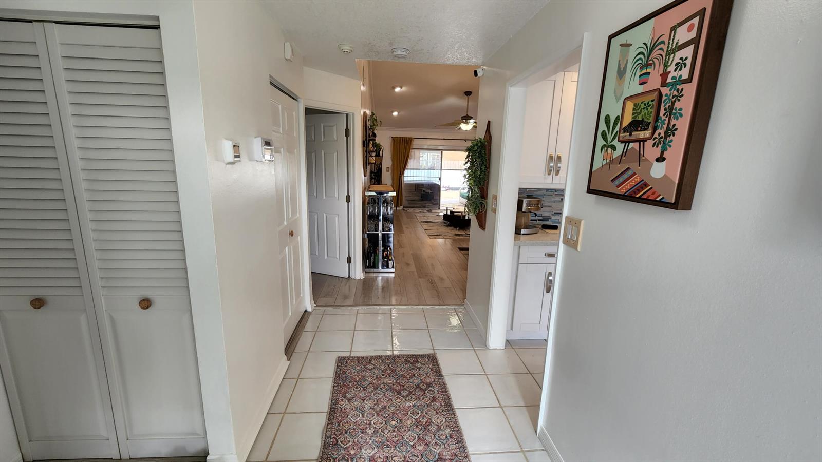 A tiled entryway leads to a hallway with wood flooring and a view of the living area — 1101 SW 111th Terrace, Davie FL 33324, DAVIE, FL