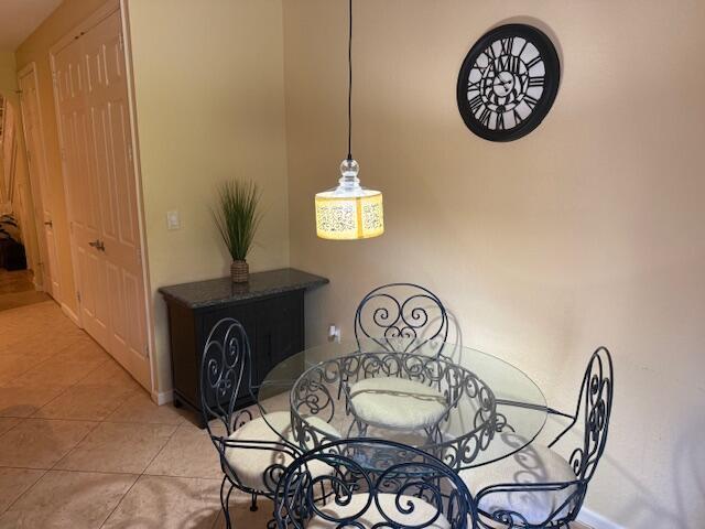 A dining area features a glass-topped table with four metal chairs and a pendant light — 3171 SW Otter Lane, Stuart FL 34997, STUART, FL