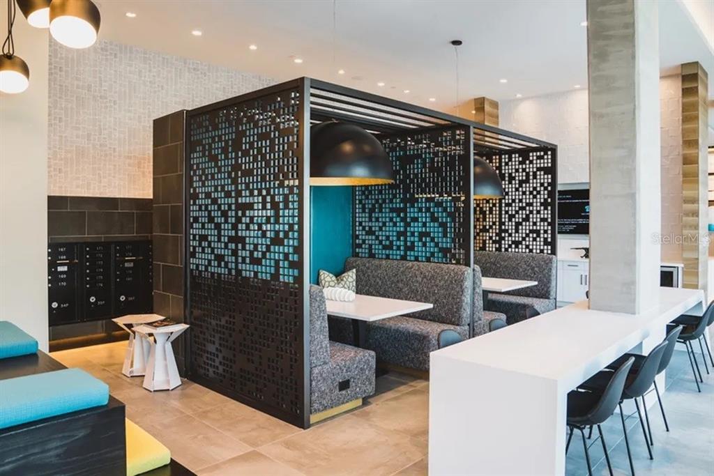 A modern lounge area features partitioned booth seating, a long white counter, and black mailboxes — 505 CHATHAM AVENUE, ORLANDO, FL