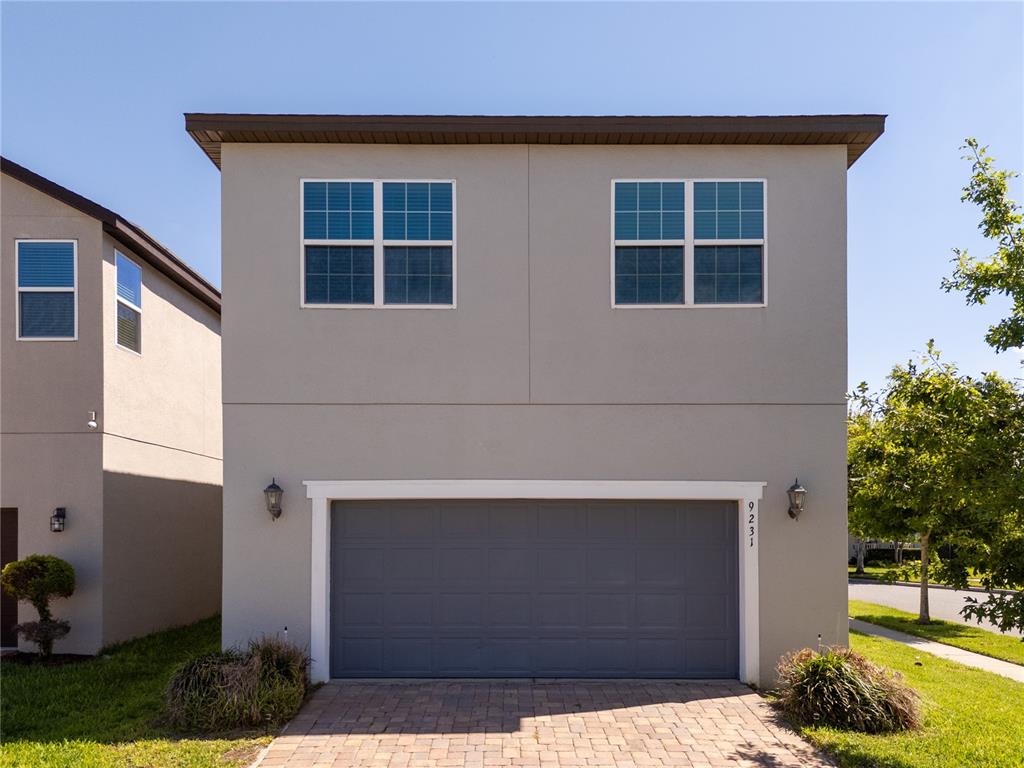 A two-story house with a gray stucco exterior and a two-car garage — 9231 GRAND ISLAND WAY, WINTER GARDEN, FL