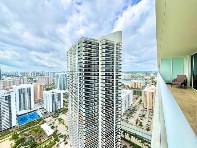 A high-angle view shows a modern skyscraper overlooking a city and a nearby marina — 1830 S Ocean Dr # 3702, Hallandale Beach FL 33009, HALLANDALE BEACH, FL