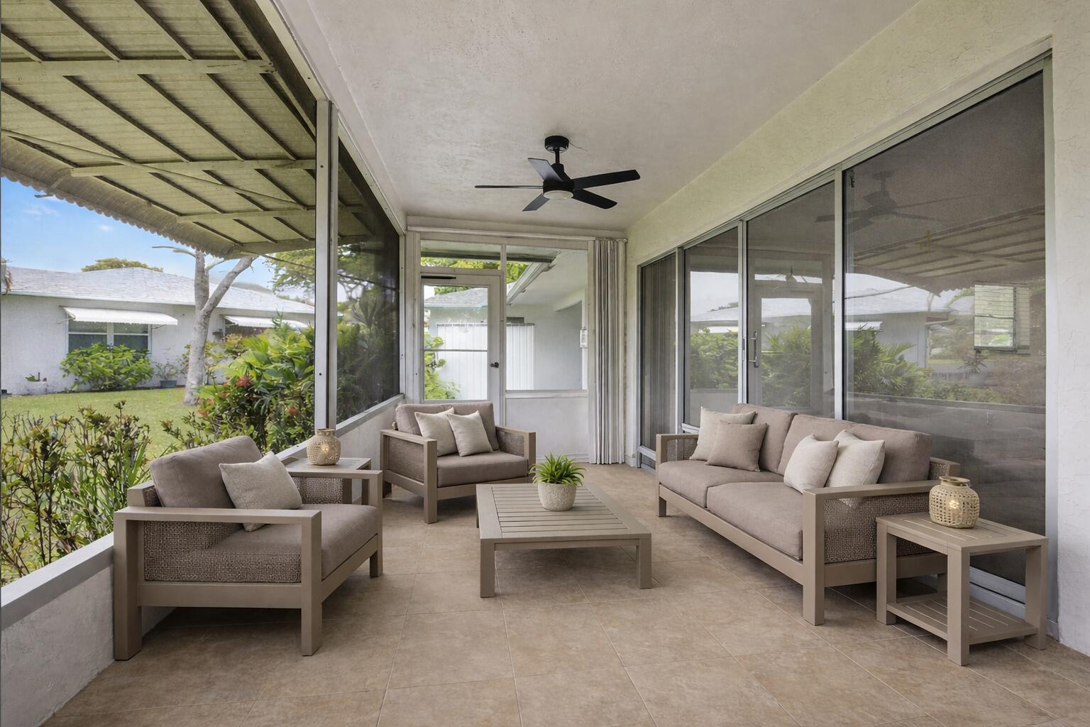 A screened-in patio features tile flooring, outdoor furniture, and a ceiling fan — 801 Meadowlark Lane, Delray Beach FL 33445, DELRAY BEACH, FL