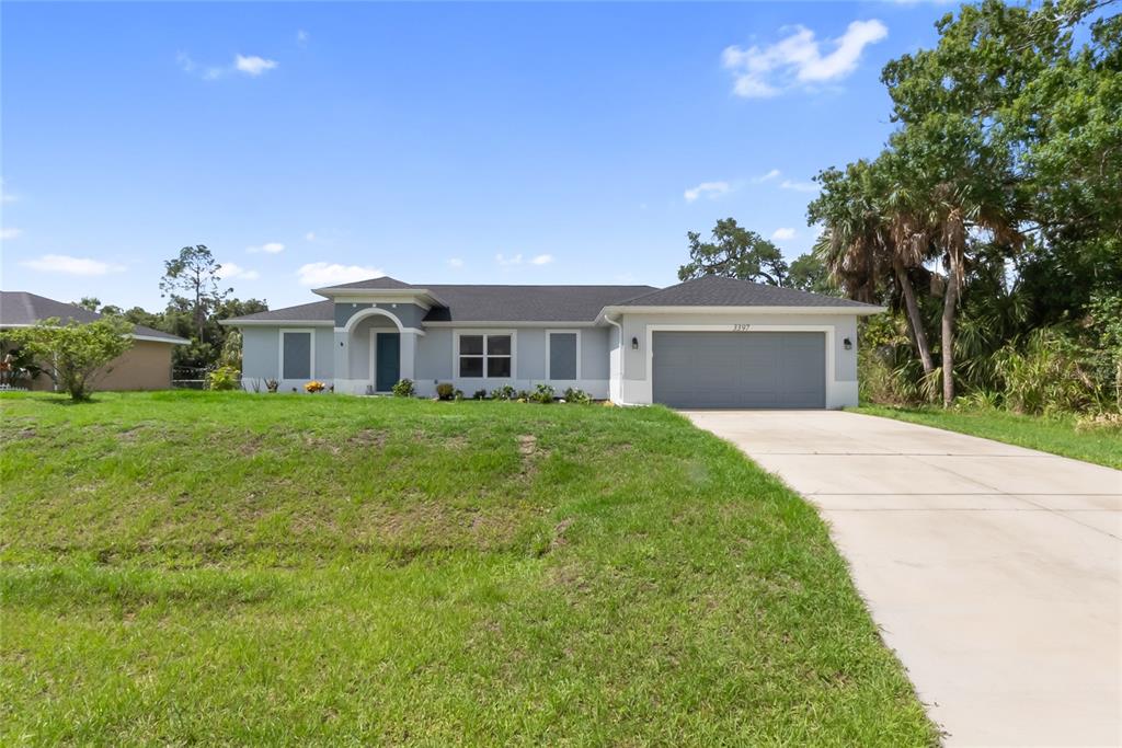 A single-story house with a gray exterior, a two-car garage, and a concrete driveway — 3397 ZORATOA AVENUE, NORTH PORT, FL