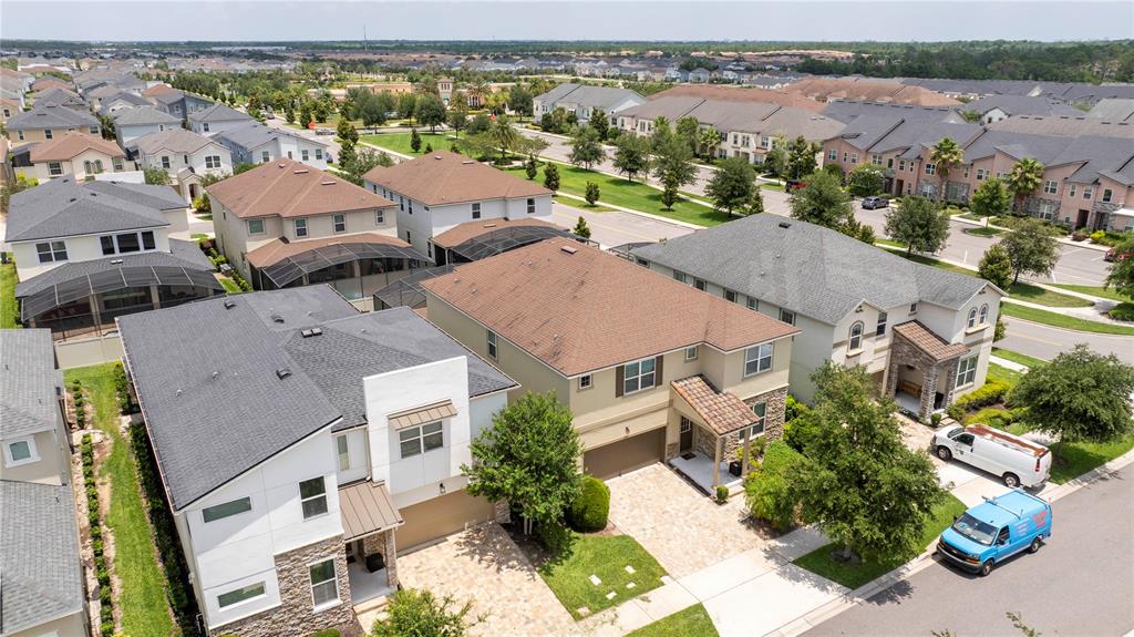 An aerial view of suburban houses with paved driveways and green lawns — 1505 NASSAU POINT TRAIL, KISSIMMEE, FL