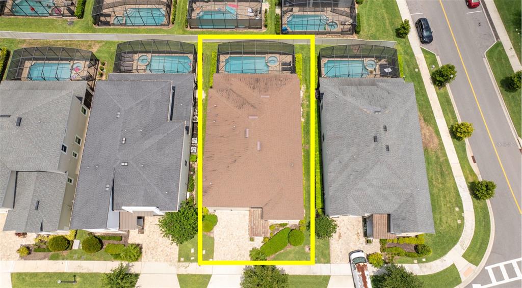 An aerial view shows a residential house with a brown roof and a screened pool — 1505 NASSAU POINT TRAIL, KISSIMMEE, FL