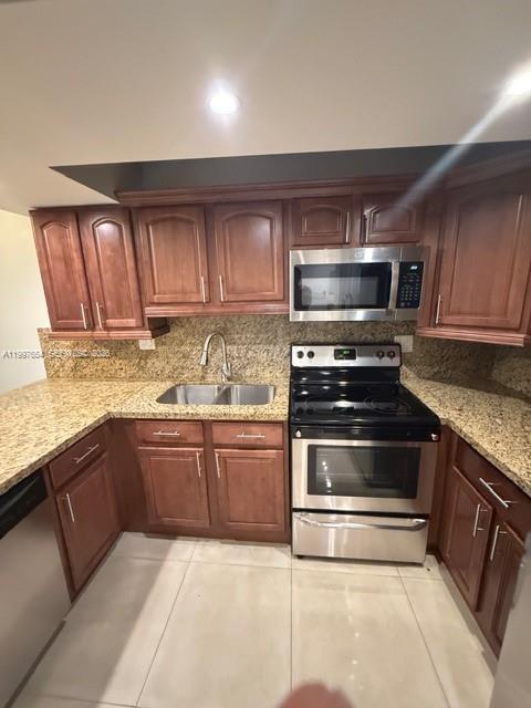 A kitchen features wood cabinets, granite countertops, and stainless steel appliances — 100 Lakeview Dr # 115, Weston FL 33326, WESTON, FL