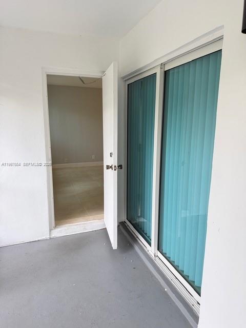 A view from a balcony looking into an interior room through an open door — 100 Lakeview Dr # 115, Weston FL 33326, WESTON, FL