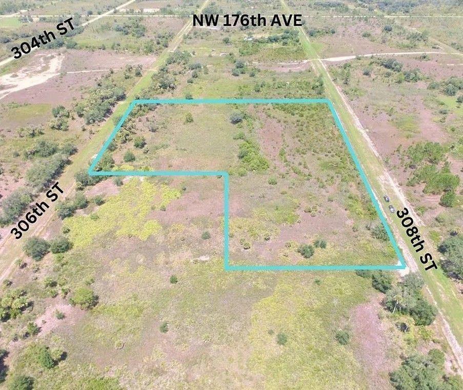 An aerial view shows an L-shaped plot of undeveloped land outlined in blue — 17065 NW 306th Street, Okeechobee FL 34972, OKEECHOBEE, FL