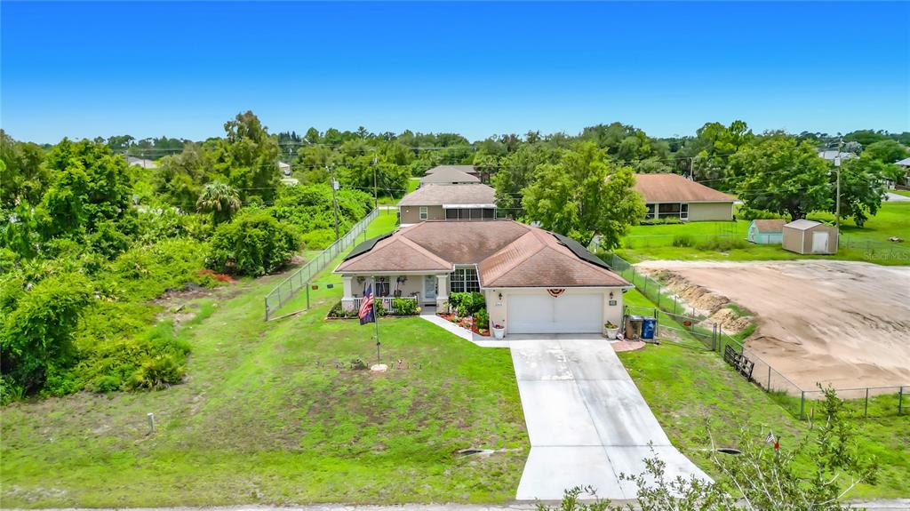 An aerial view shows a single-story house with a two-car garage and a concrete driveway — 2903 38TH STREET SW, LEHIGH ACRES, FL