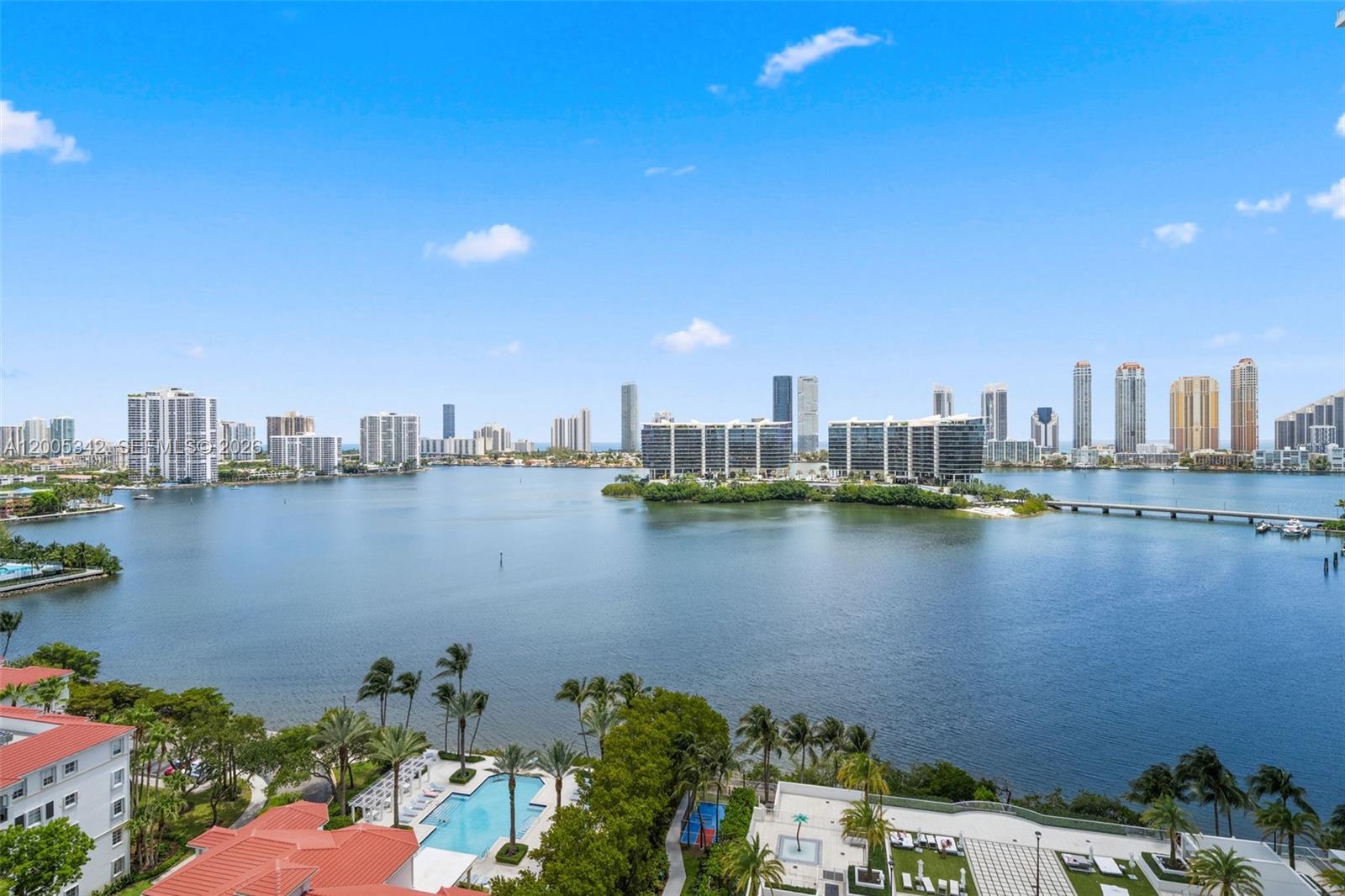 An elevated view shows a bay surrounded by high-rise buildings, palm trees, and a pool — 3301 NE 183rd St # 1604, Aventura FL 33160, AVENTURA, FL